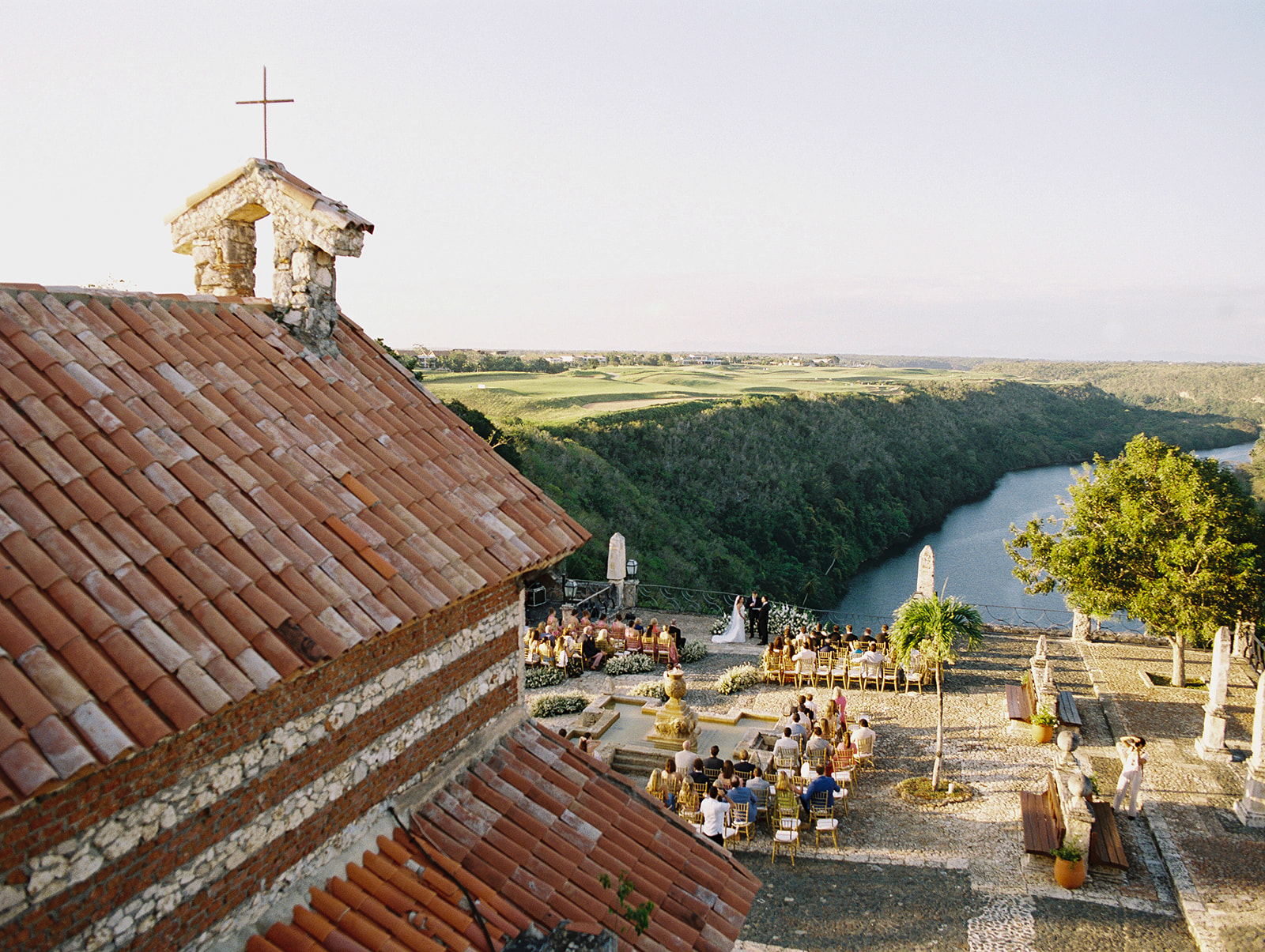 Wedding ceremony at Altos de Chavón above the Chavón River in golden evening light
