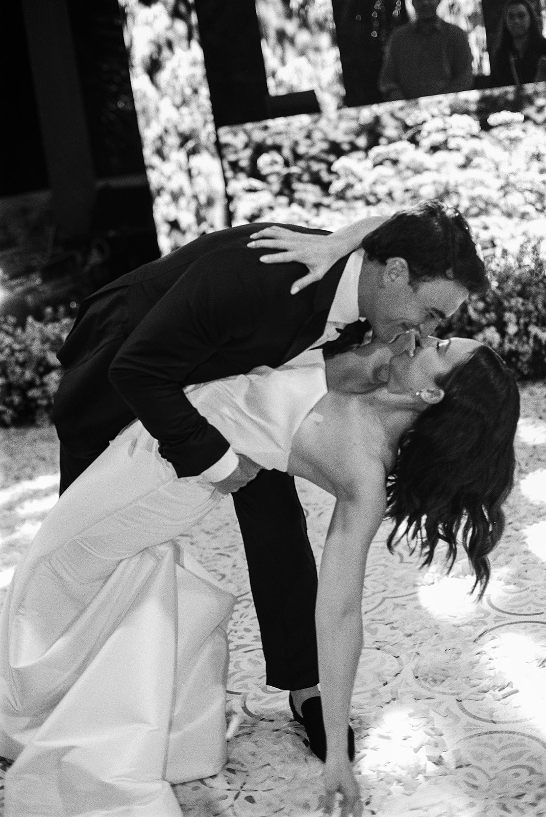 Groom dipping the bride into a kiss during their first dance at Casa de Campo