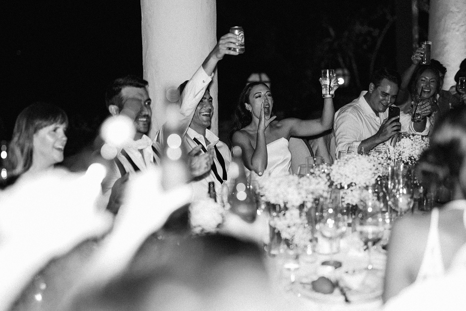 Wedding guests raising their glasses in a toast at a Casa de Campo reception