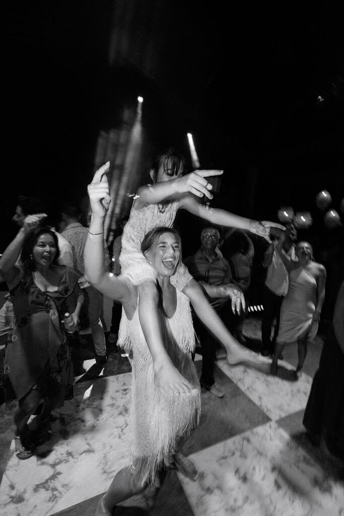 Black and white photo of the bride dancing with guests at the reception, Casa Colonial, Puerto Plata