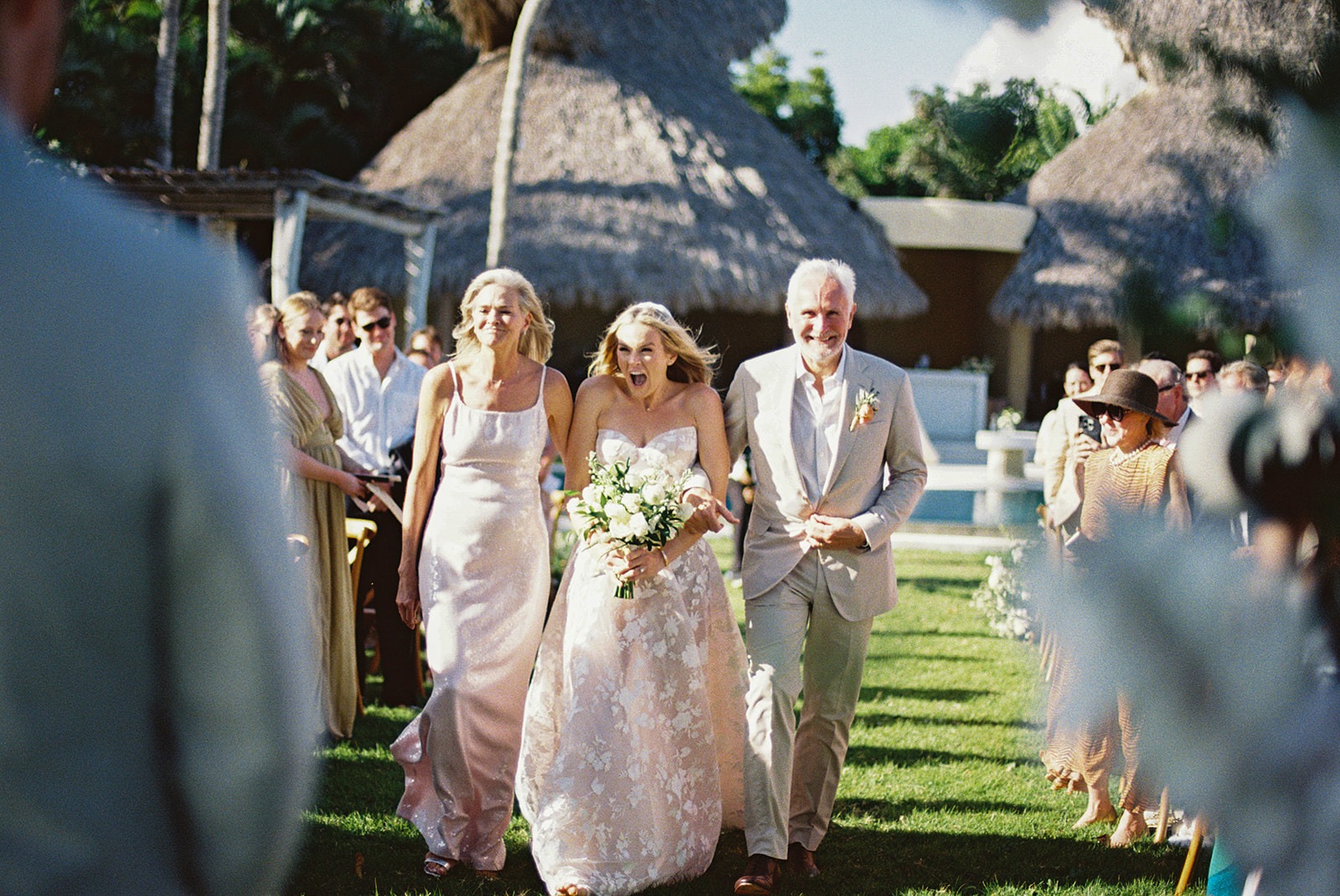 Bride walking down aisle with parents, Lauren & August's Casa de Campo wedding, Dominican Republic