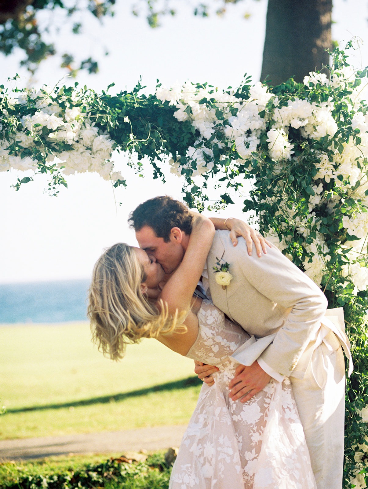 Newlywed kiss floral arch, Lauren & August's Casa de Campo wedding, Dominican Republic