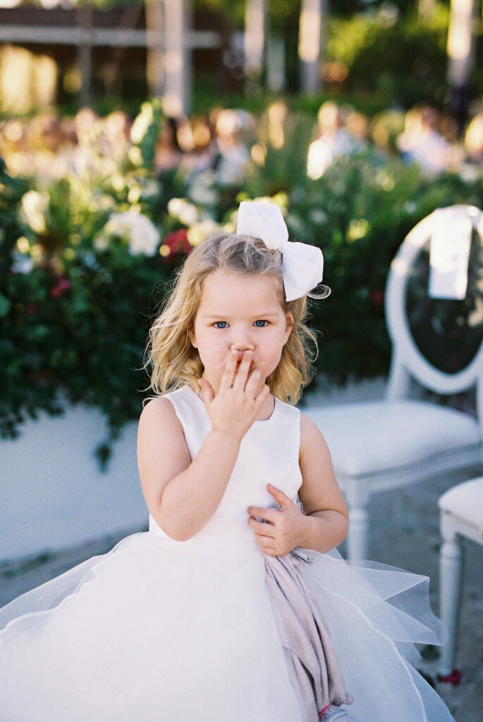 Flower girl blowing a kiss during the ceremony, Casa de Campo wedding, Dominican Republic