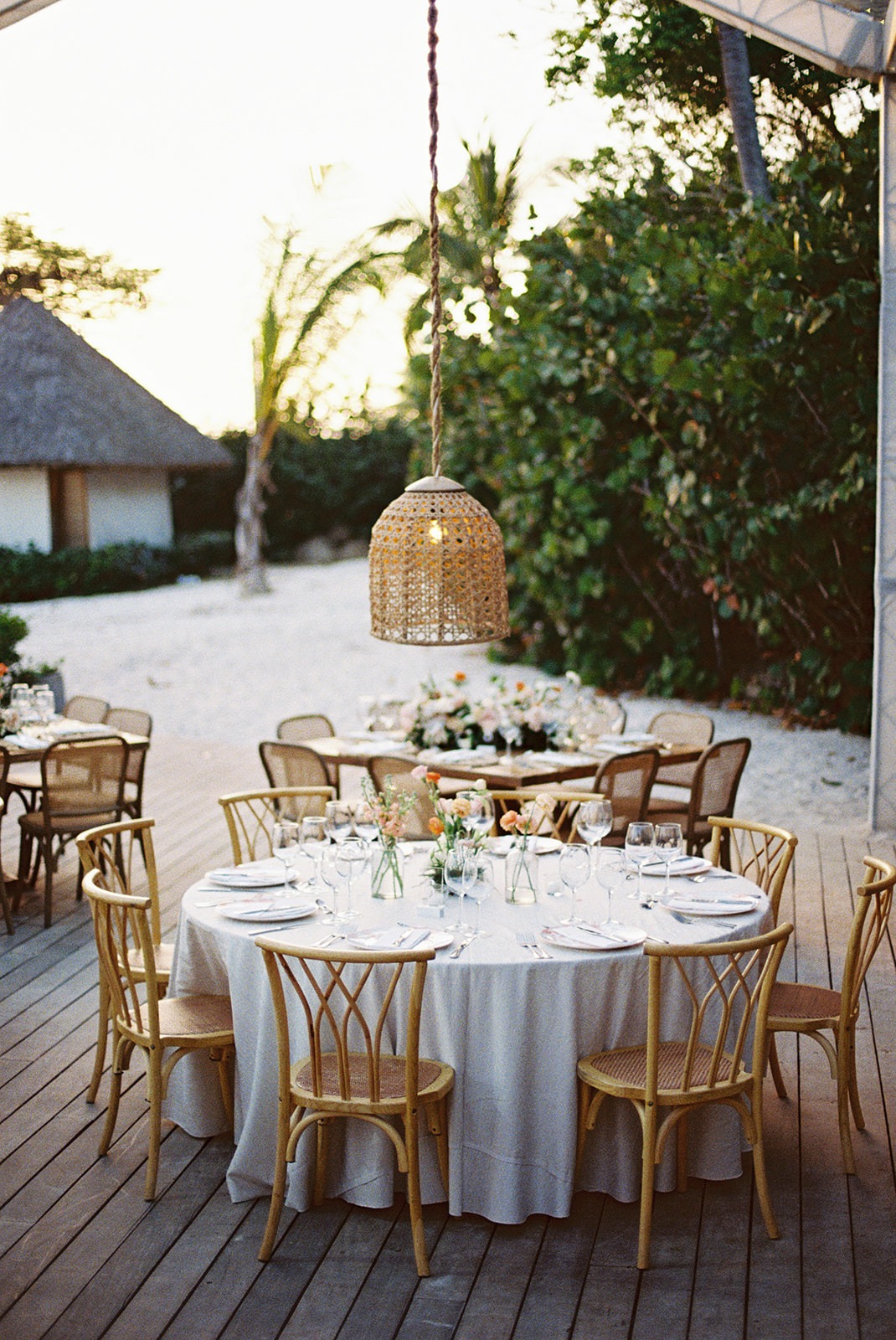 Reception table rattan pendant lights, Lauren & August's Casa de Campo wedding, Dominican Republic