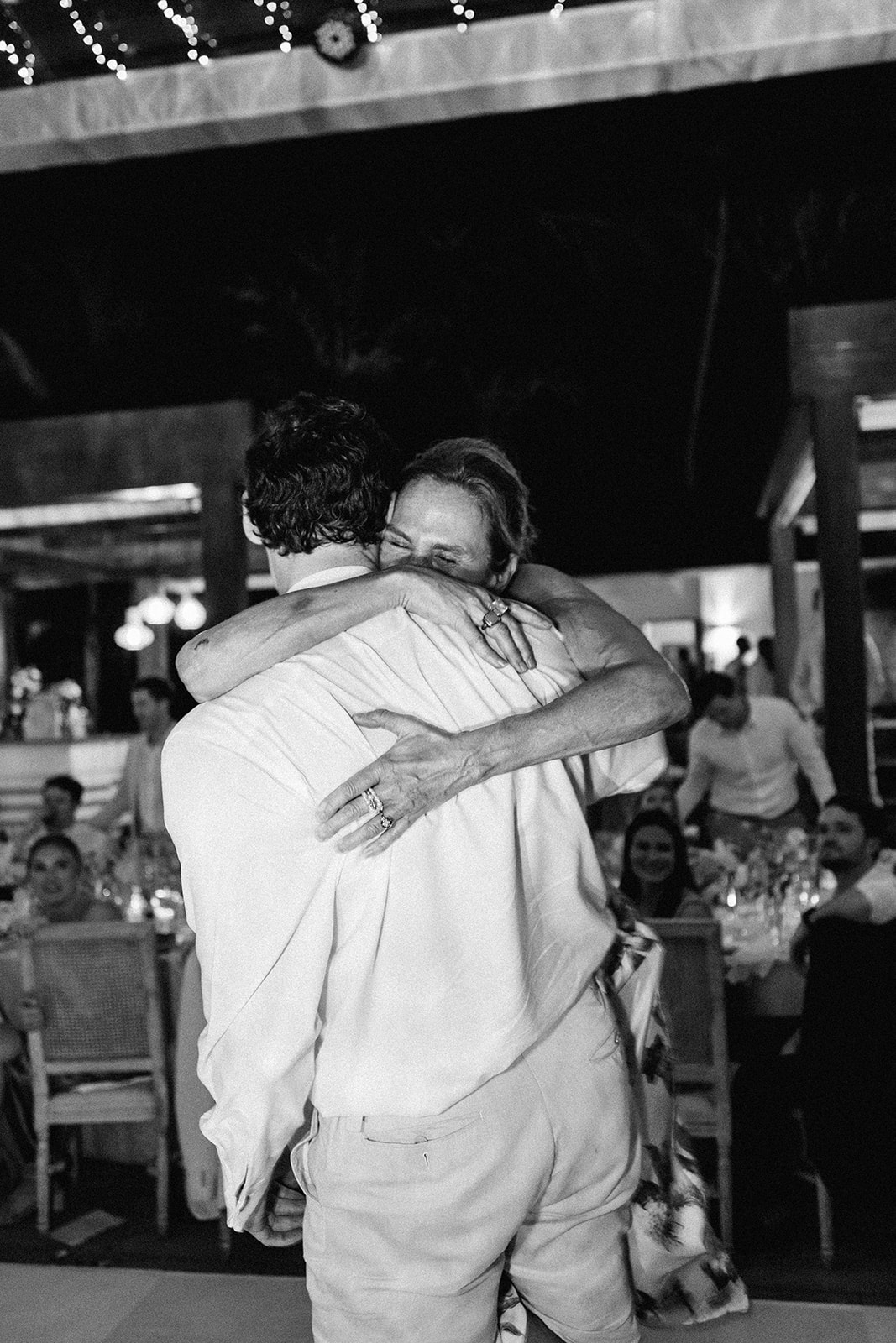 Guest emotional hug black and white, Lauren & August's Casa de Campo wedding, Dominican Republic