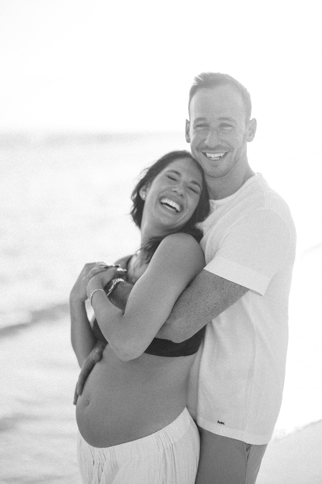 Black and white portrait of couple embracing and smiling at Casa de Campo Resort