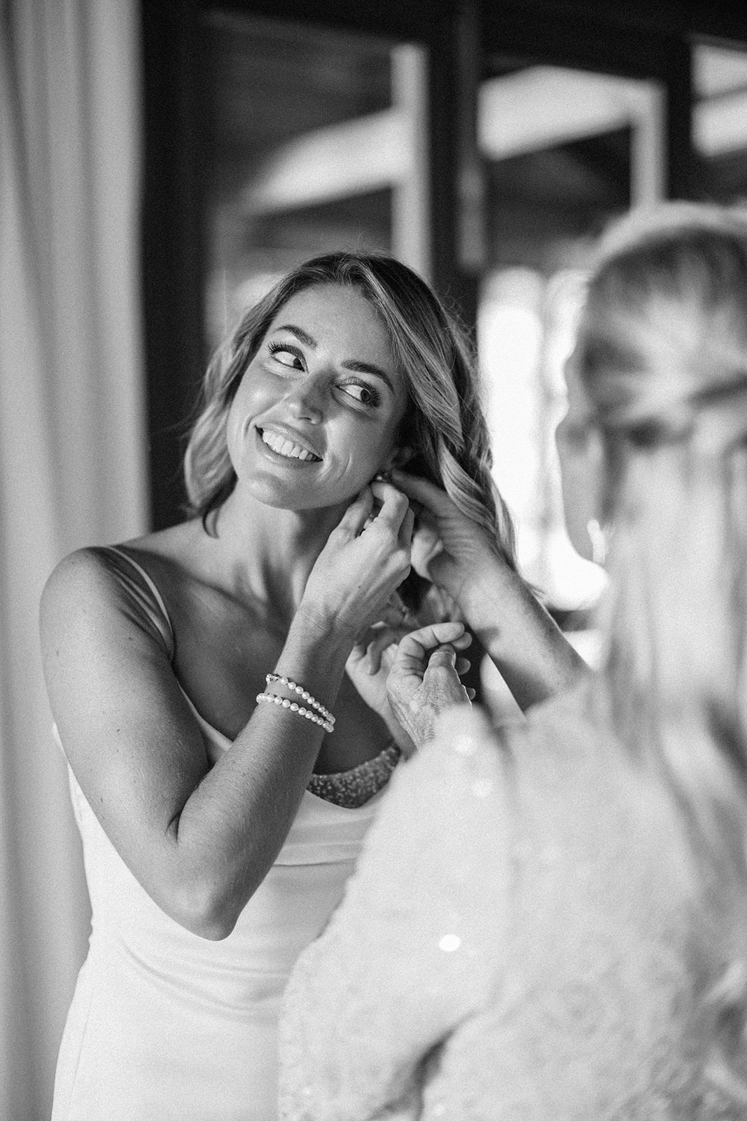 Elizabeth smiling while putting in her earring