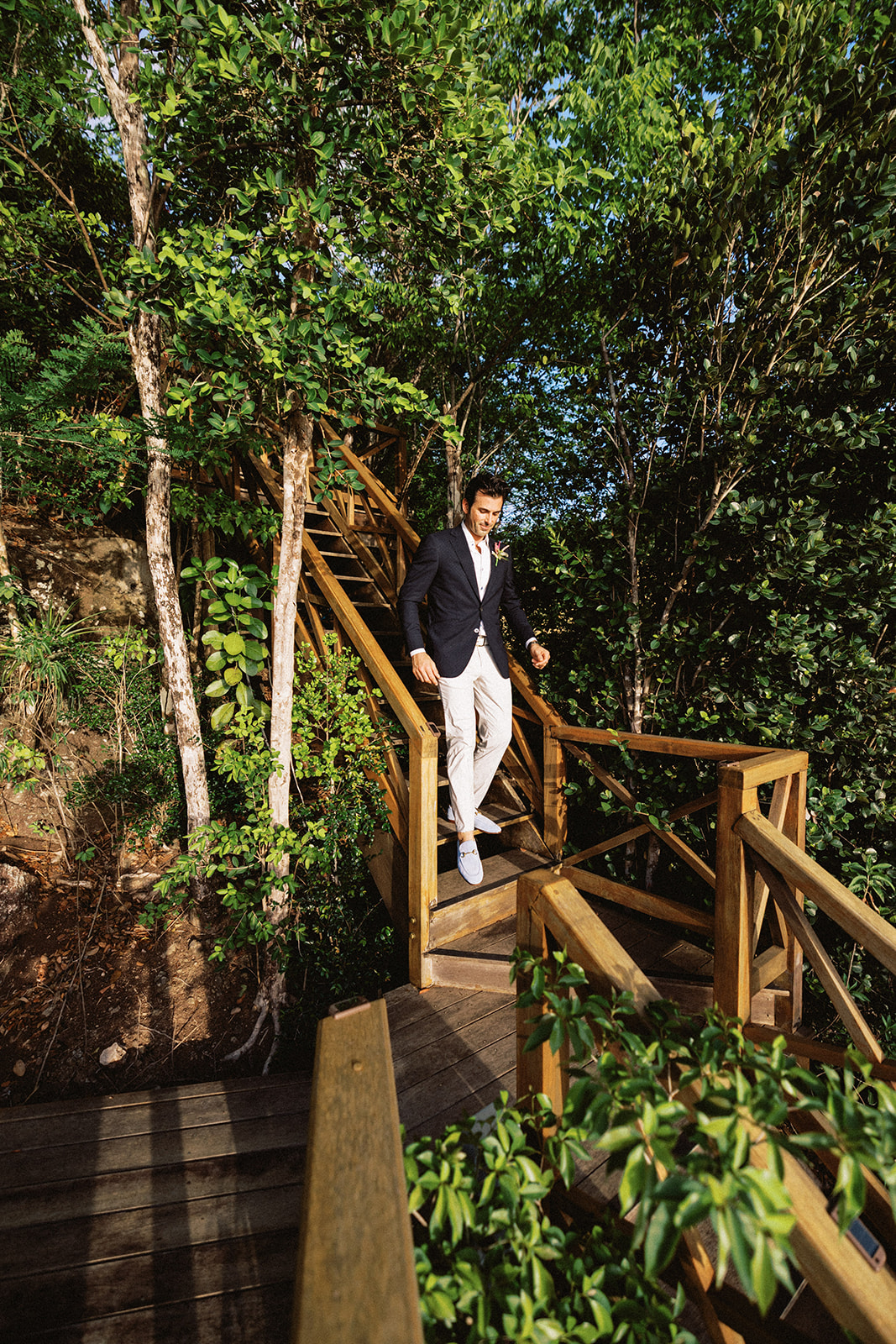 Aaron walking down the wooden steps to the ceremony