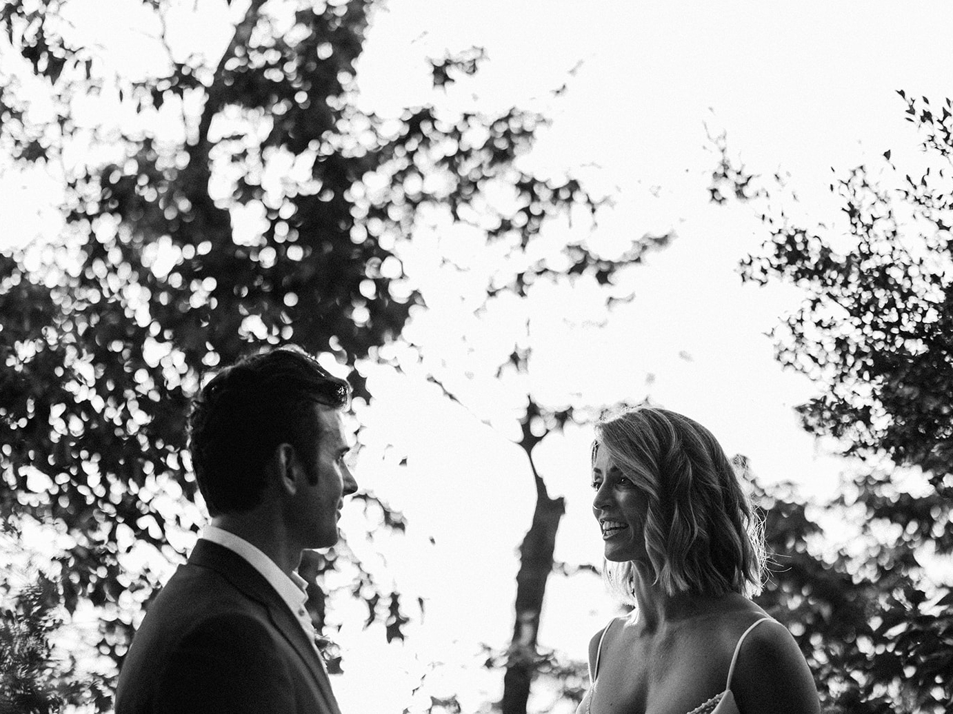 Elizabeth and Aaron in silhouette during the ceremony, black and white