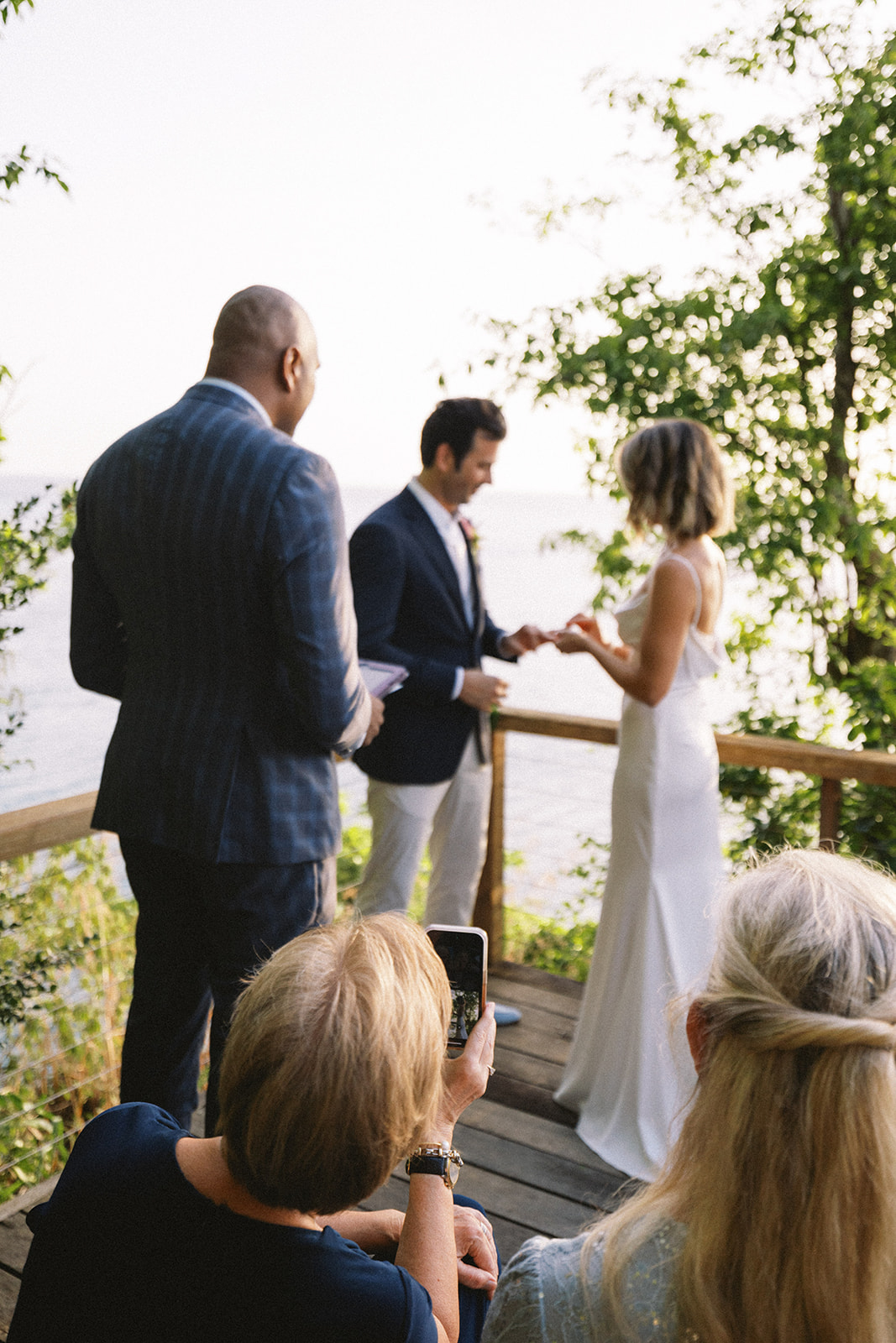 Elizabeth and Aaron exchanging vows, officiant beside them