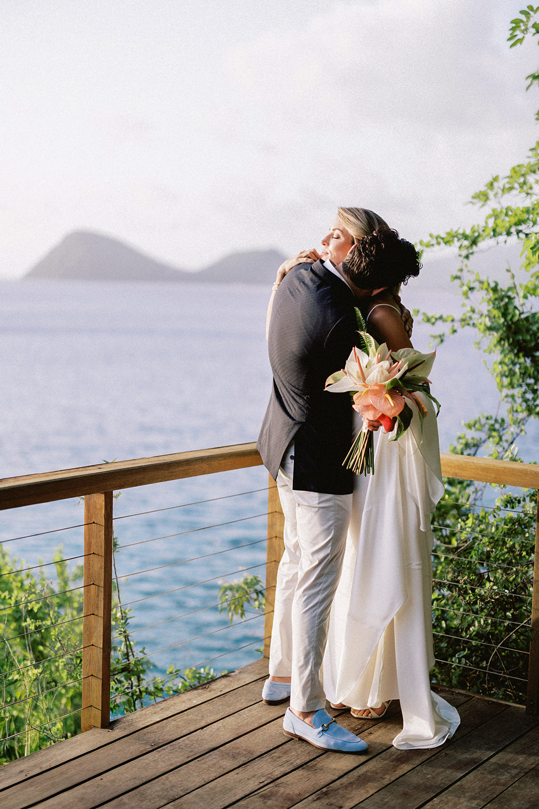 Elizabeth's mother embracing her, islands visible in the background